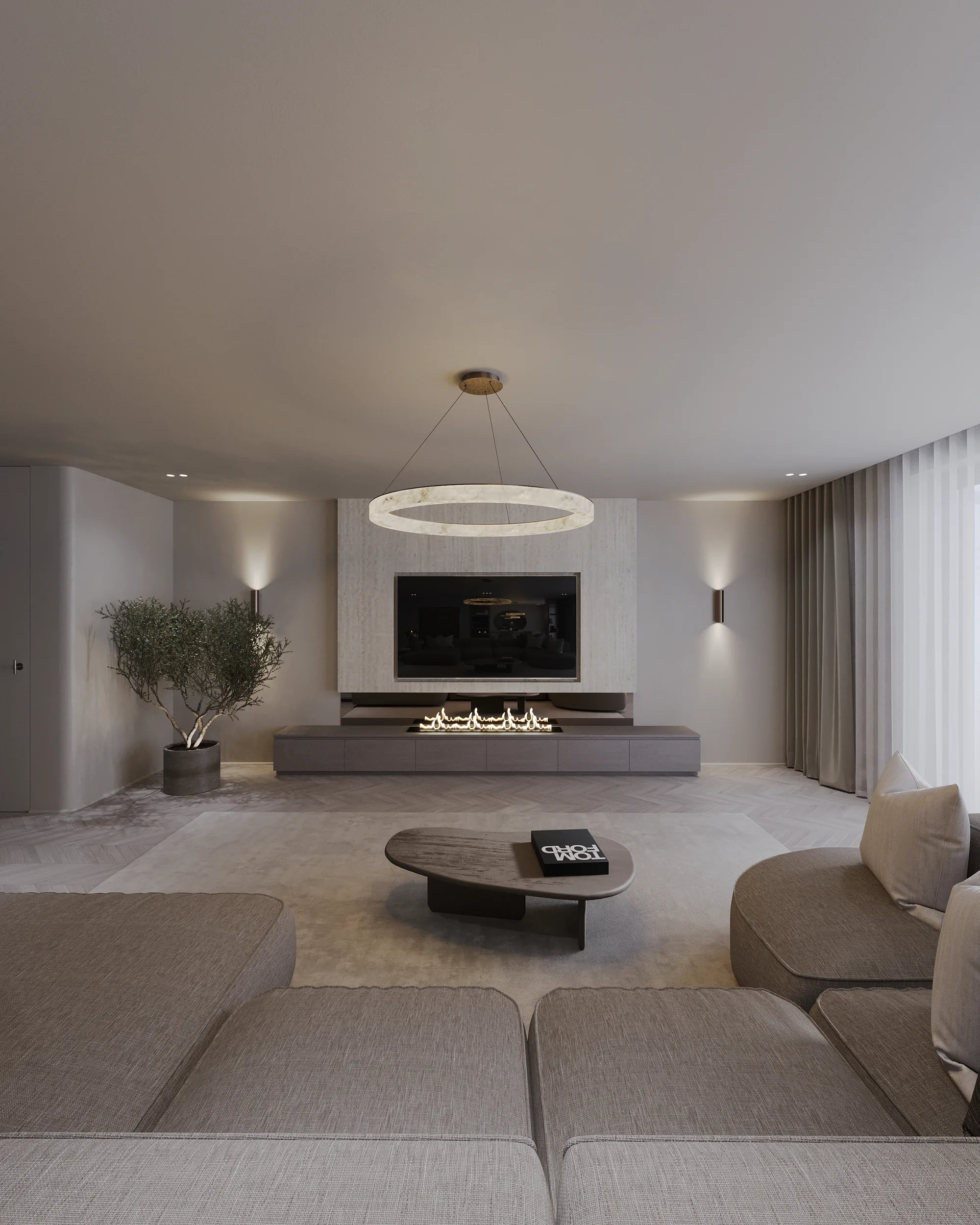 Woonkamer met haard, ronde salontafels en het ringarmatuur